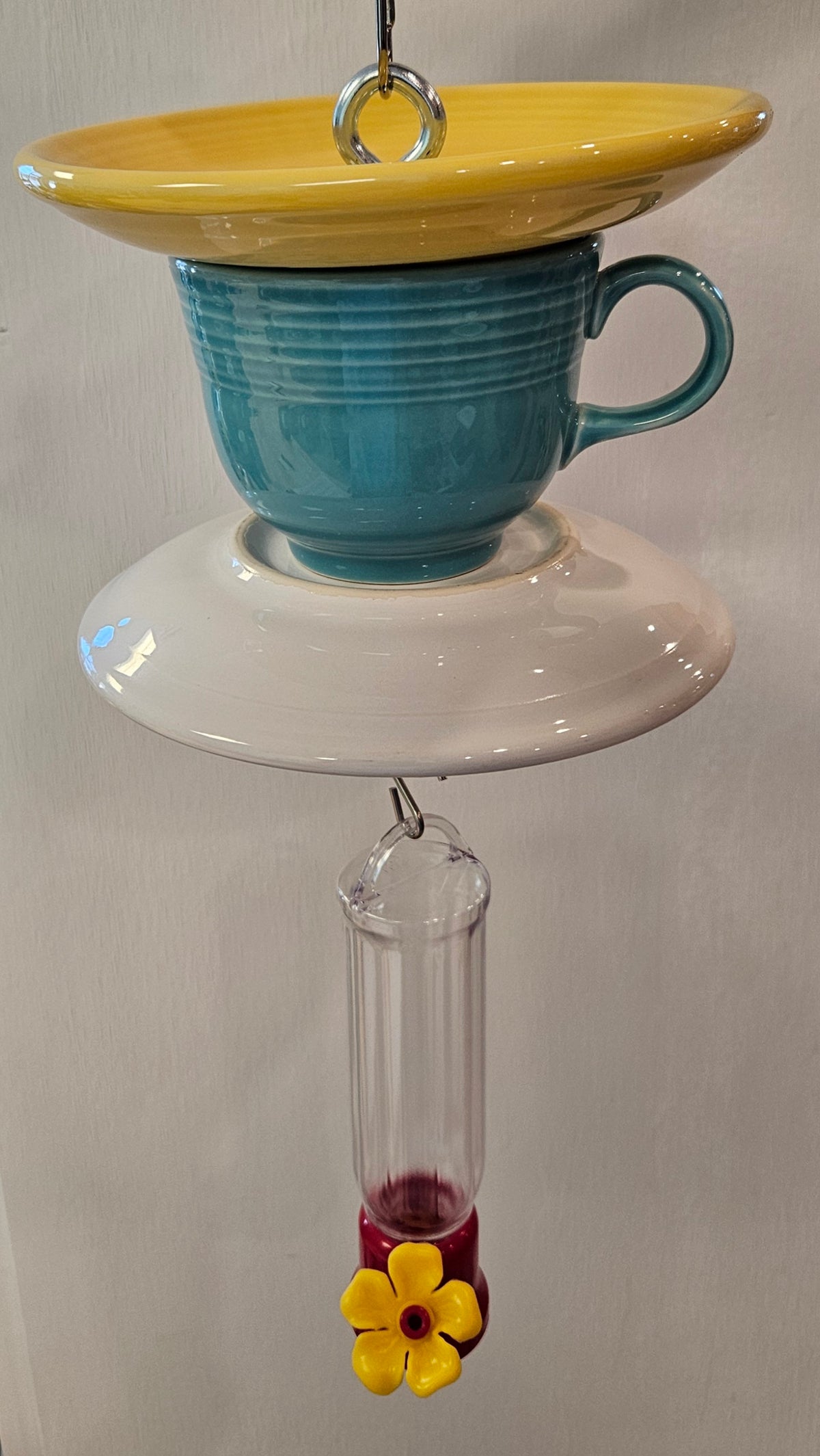 This is a handcrafted Hummingbird Feeder made from a Fiesta Fiestaware Cup and two saucers. It includes a plastic nectar holder. While not included but shown in additional pictures, these can be used to hold chimes, a windsock, or other decoration. Please see item description for specific cup and saucer color.  Crafted, Fiesta Second Life. Fiesta  Bird Feeder
