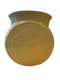 A round ceramic vase with a flared rim, featuring concentric circular ridges on the side, in a warm mustard yellow color, isolated on a white background. Fiesta Millennium II Vase in Yellow