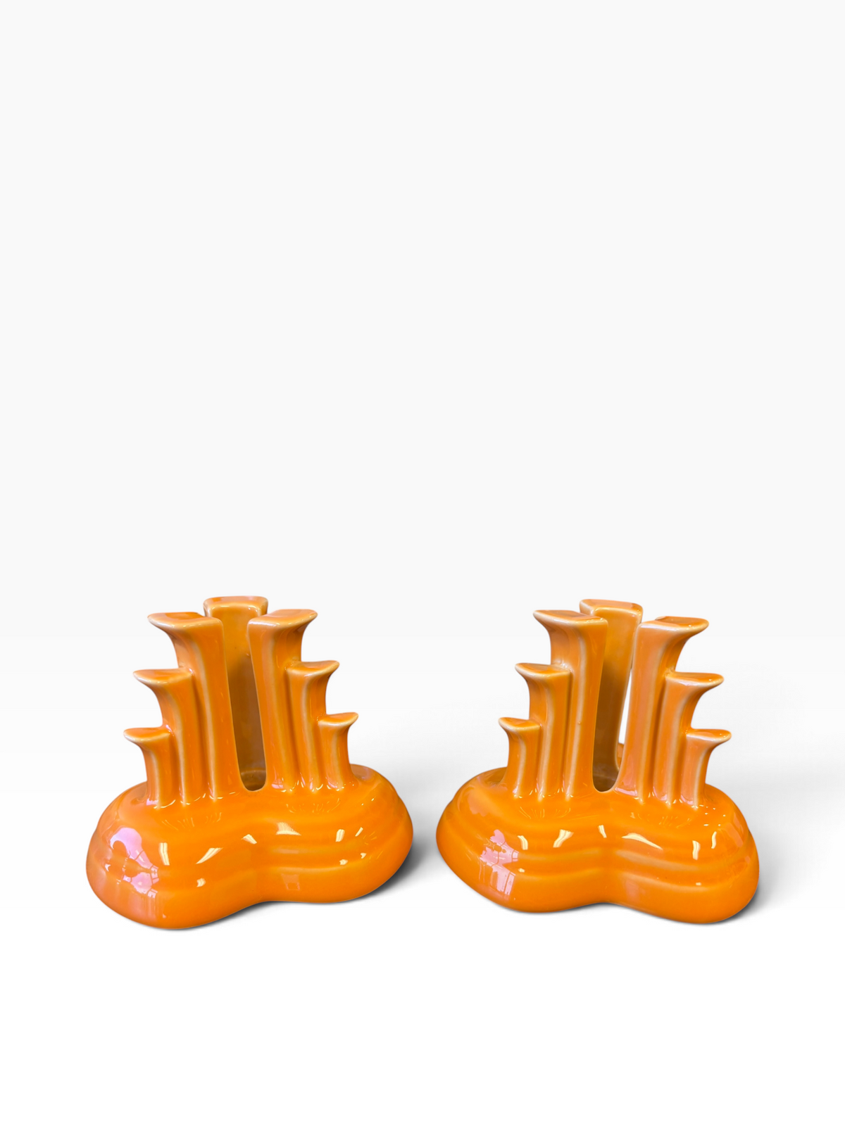 Fiesta pyramid candle holders are collectible, tripod-shaped ceramic candle pieces produced in limited, numbered runs by the iconic tabletop brand. These are in the beautiful tangerine orange glaze. 