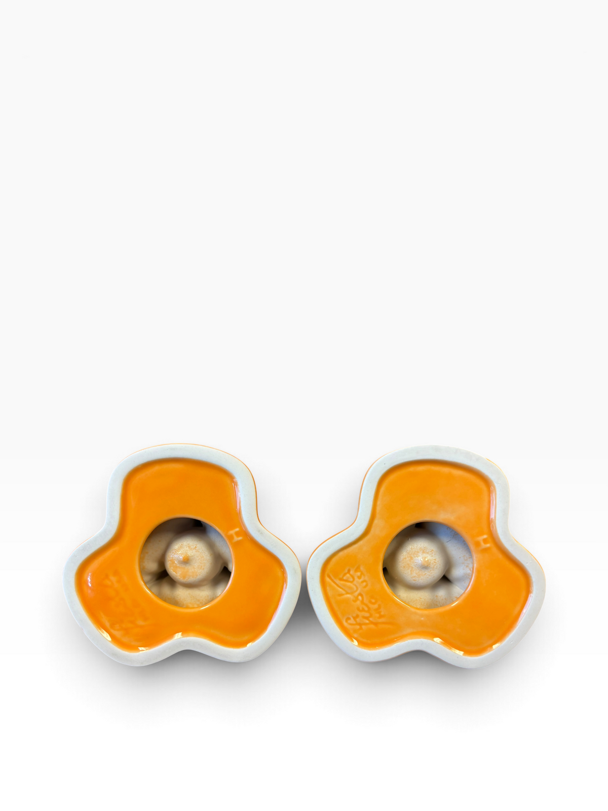 Fiesta pyramid candle holders are collectible, tripod-shaped ceramic candle pieces produced in limited, numbered runs by the iconic tabletop brand. These are in the beautiful tangerine orange glaze. 