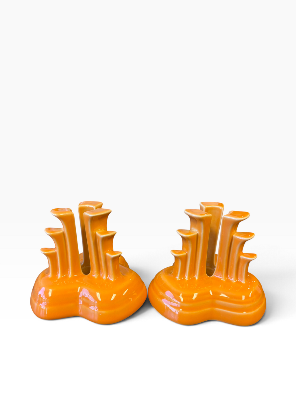 Fiesta pyramid candle holders are collectible, tripod-shaped ceramic candle pieces produced in limited, numbered runs by the iconic tabletop brand. These are in the beautiful tangerine orange glaze. 