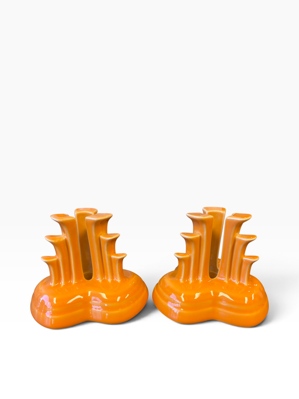Fiesta pyramid candle holders are collectible, tripod-shaped ceramic candle pieces produced in limited, numbered runs by the iconic tabletop brand. These are in the beautiful tangerine orange glaze. 