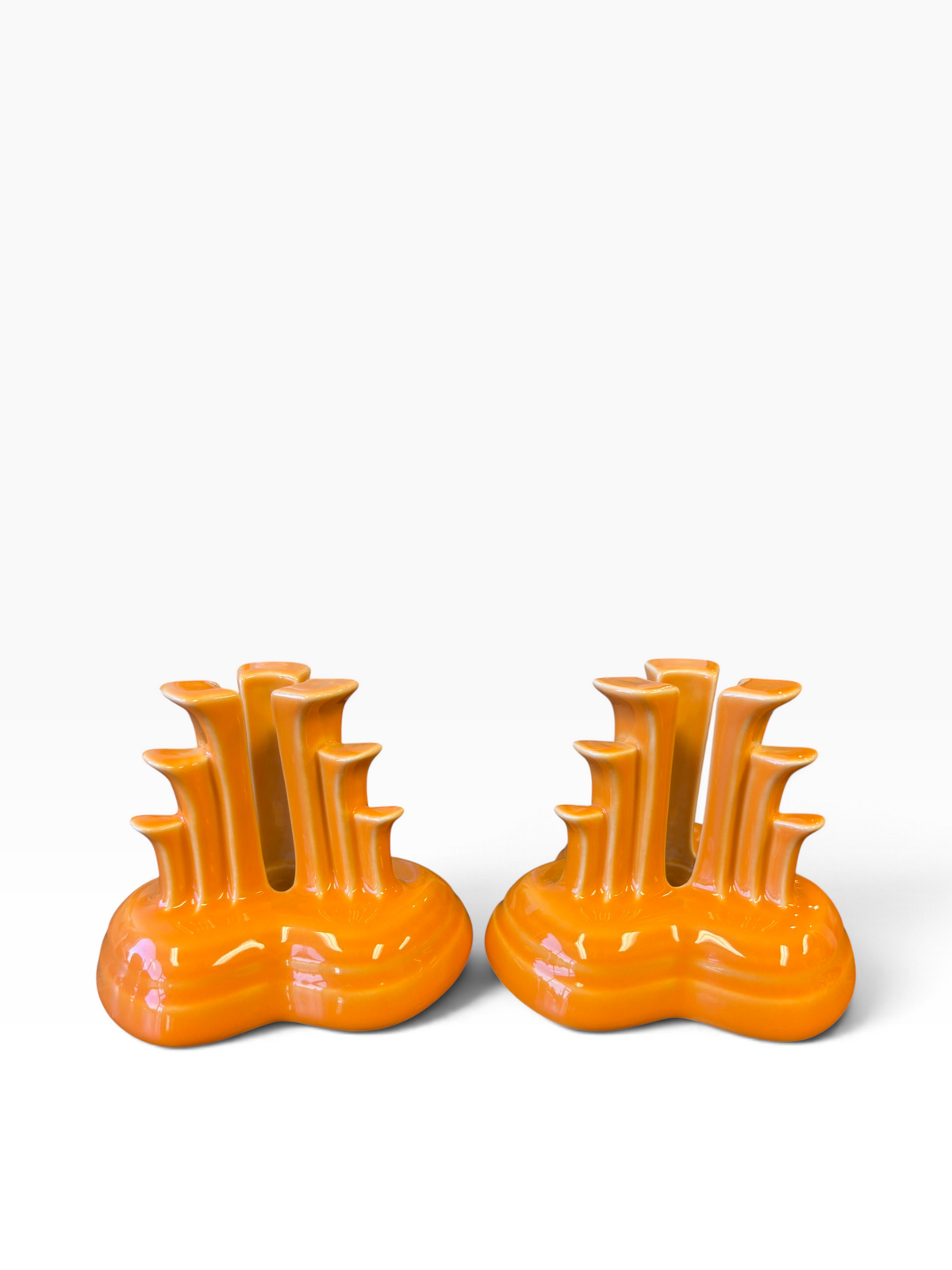 Fiesta pyramid candle holders are collectible, tripod-shaped ceramic candle pieces produced in limited, numbered runs by the iconic tabletop brand. These are in the beautiful tangerine orange glaze. 