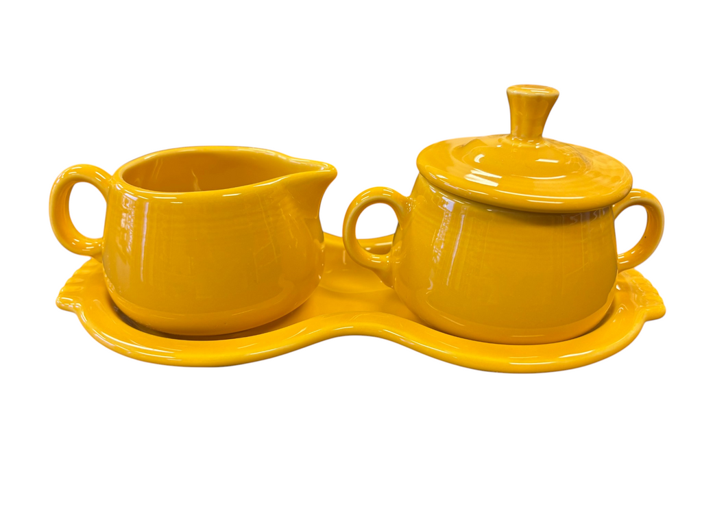 This is a Fiesta Fiestaware Creamer Pitcher Sugar Bowl with Lid on Figure Eight 8 Tray Set in marigold lead-free, Post 1986, Retired Color Retired Shape

