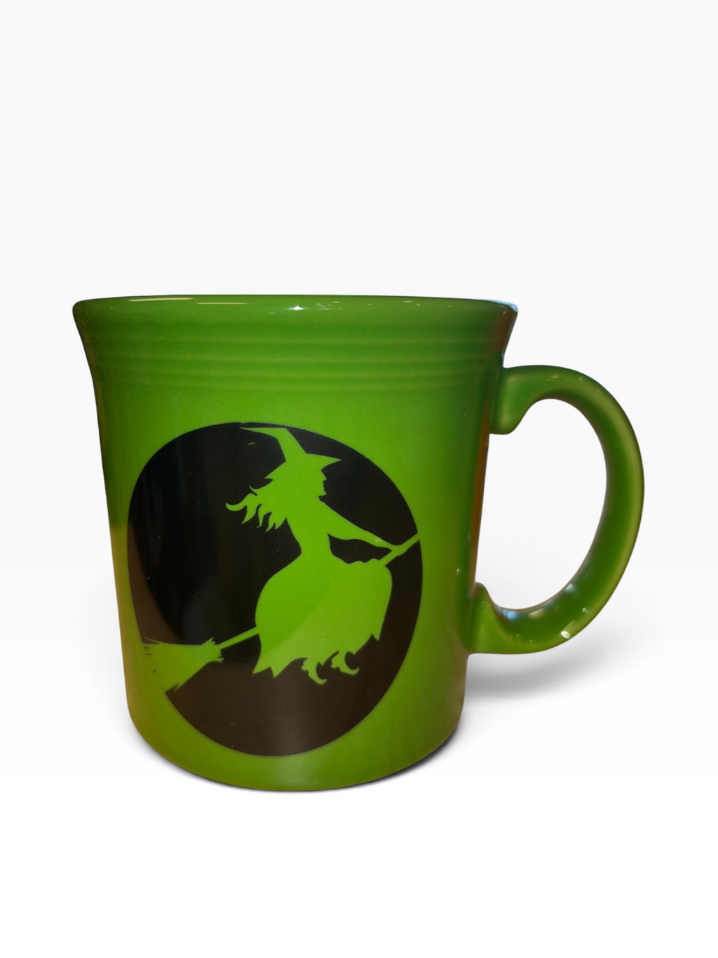 This is a Fiesta fiestware Java Mug featuring the Harvest Moon Witch decal on shamrock. Lead free Post 1986 Retired Color Retired Decal Halloween
