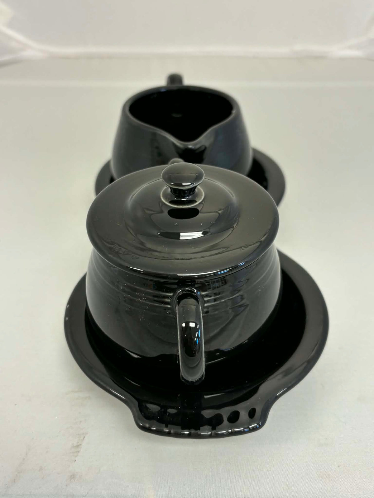 This is a Fiesta Fiestaware Creamer Pitcher Sugar Bowl with Lid on Figure Eight 8 Tray Set in black. lead-free, Post 1986, Retired Color Retired Shape
