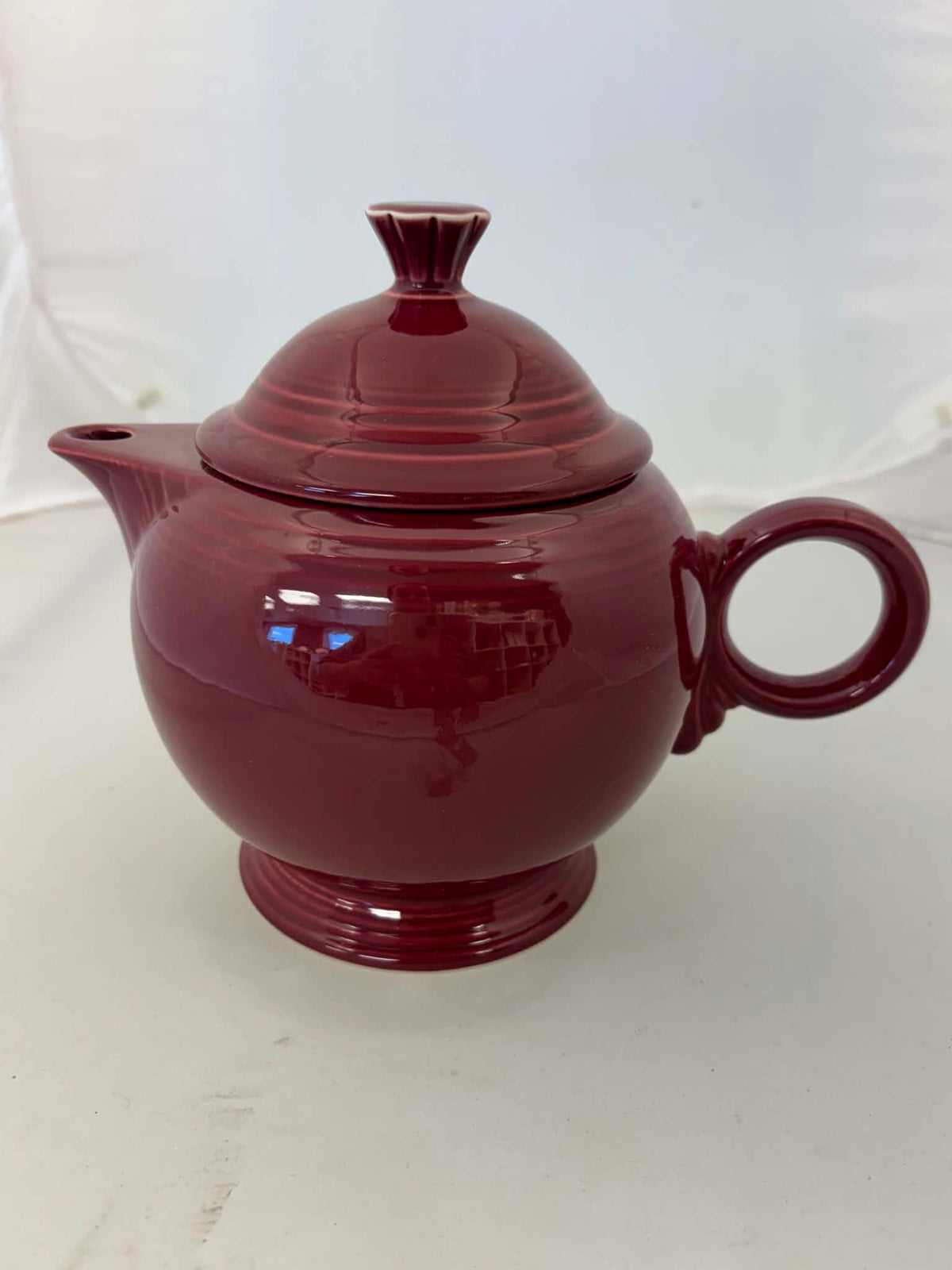 This is a Fiesta Fiestaware Five-cup 5-cup Ring Handled Tea Pot with Lid in Cinnabar. lead-free, Post 1986, Retired Color Retired Shape
