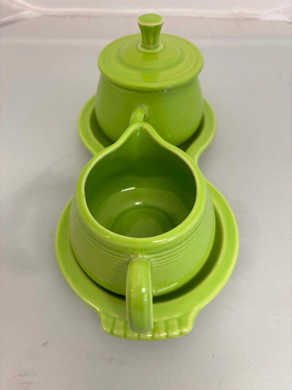 This is a Fiesta Fiestaware Creamer Pitcher Sugar Bowl with Lid on Figure Eight 8 Tray Set in chartreuse lead-free, Post 1986, Retired Color Retired Shape
