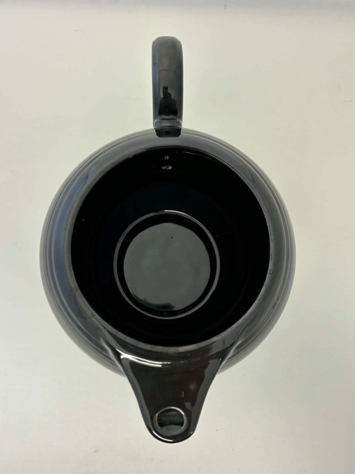 This is a Fiesta Fiestaware Five-cup 5-cup Ring Handled Tea Pot with Lid in Black. lead-free, Post 1986, Retired Color Retired Shape
