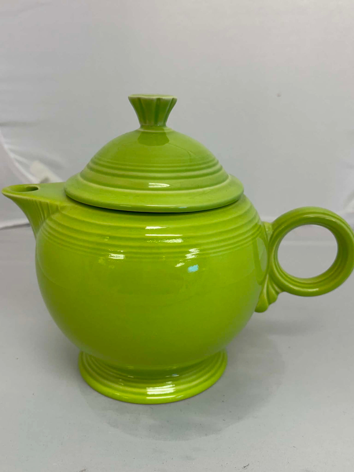 This is a Fiesta Fiestaware Five-cup 5-cup Ring Handled Tea Pot with Lid in Chartreuse. lead-free, Post 1986, Retired Color Retired Shape
